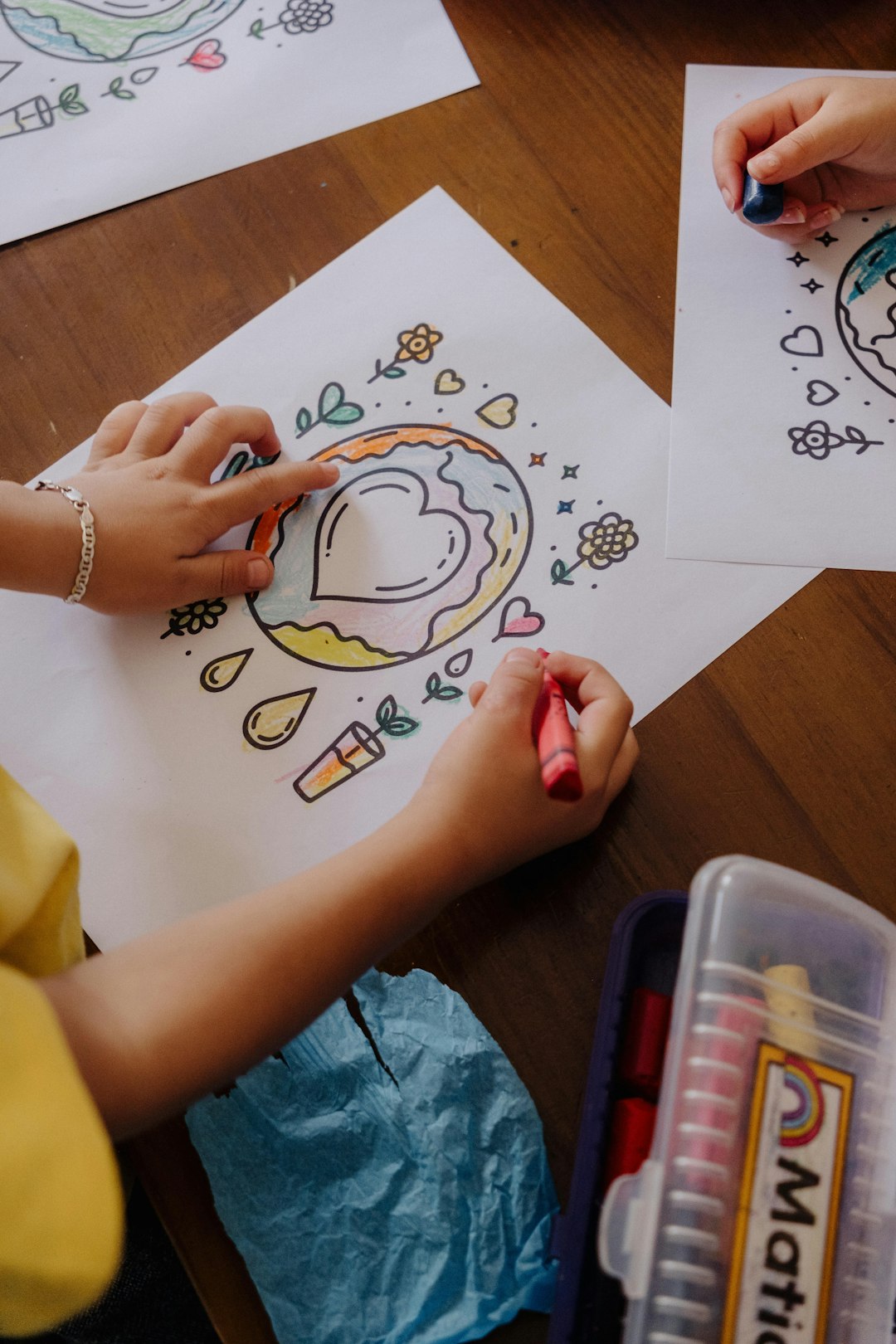 A Child Is Drawing On Paper With Crayons Hpsyrftkjd8