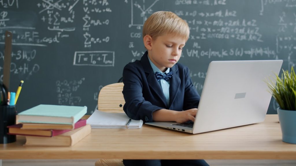 Boy In Suit Using Laptop In Classroom Kotq96r2m6e 1024x576