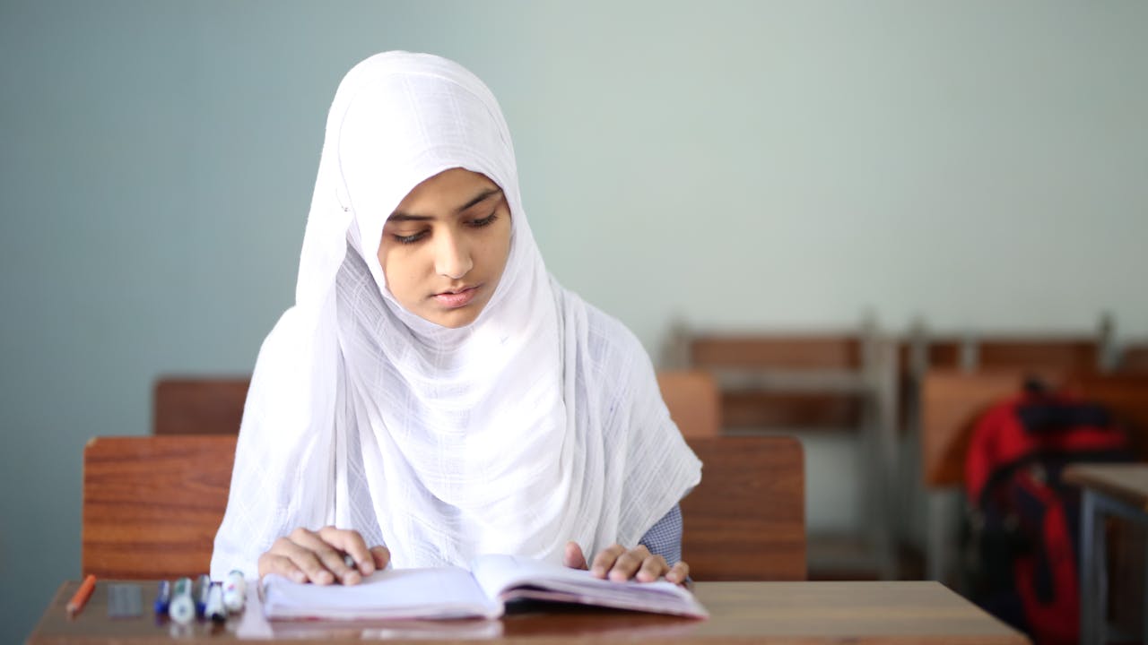 Close Up Photo Of A Diligent Student Reading A Book 12714670